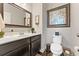 Neutral bathroom features a granite vanity, decorative mirror, and modern fixtures at 1972 Clovercroft Rd, Acworth, GA 30101