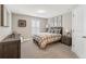 Comfortable bedroom with neutral decor, a window with shutters, carpeted floors, and a side table lamp at 1972 Clovercroft Rd, Acworth, GA 30101