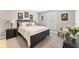 Charming bedroom featuring a dark wood bed frame, neutral walls, and bright natural light at 1972 Clovercroft Rd, Acworth, GA 30101