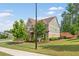 Attractive home displaying well-manicured lawn with mature trees and manicured shrubs at 1972 Clovercroft Rd, Acworth, GA 30101