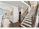 Elegant foyer features hardwood floors, staircase with iron spindles, and arched doorway leading to the front door at 1972 Clovercroft Rd, Acworth, GA 30101