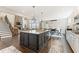Open-concept kitchen with a large center island, stainless steel appliances, and an adjacent living area at 1972 Clovercroft Rd, Acworth, GA 30101