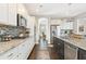 This modern kitchen offers granite countertops, stainless steel appliances, white cabinetry, and an eat-in area at 1972 Clovercroft Rd, Acworth, GA 30101