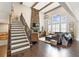 Open-concept living room with a stone fireplace, hardwood floors, and large windows that fill the room with light at 1972 Clovercroft Rd, Acworth, GA 30101