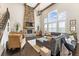 Bright living room boasts a stone fireplace, high ceilings, ample natural light, and hardwood floors at 1972 Clovercroft Rd, Acworth, GA 30101