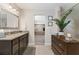 Well-lit main bathroom with granite countertops, dark cabinetry, and view to the main bedroom at 1972 Clovercroft Rd, Acworth, GA 30101