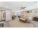 Spacious main bedroom with neutral decor, sitting area, large rug, ceiling fan, and bright natural light at 1972 Clovercroft Rd, Acworth, GA 30101