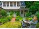 Seating area on the lawn is nestled among lush landscaping and gardens at 341 Lands Se Ml, Marietta, GA 30067