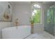 Elegant bathroom features a standalone tub with gold fixtures, mosaic tile wall, and glass-enclosed shower at 341 Lands Se Ml, Marietta, GA 30067