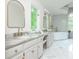 Bright bathroom featuring marble countertops, standalone tub, and modern gold fixtures at 341 Lands Se Ml, Marietta, GA 30067