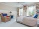 Cozy bedroom showcasing built-in shelving, soft lighting, and a comfortable armchair at 341 Lands Se Ml, Marietta, GA 30067