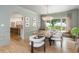 Dining room with hardwood floors, decorative chandelier, and large windows overlooking greenery at 341 Lands Se Ml, Marietta, GA 30067