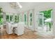 Sunlit dining area boasts terracotta floors, and views of outdoor gazebo at 341 Lands Se Ml, Marietta, GA 30067