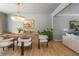 Open-concept dining area with a chandelier and bar area that flows into the living room at 341 Lands Se Ml, Marietta, GA 30067