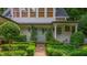 This home features a delightful outdoor bench and landscaping with an inviting garden entryway and pristine lawn at 341 Lands Se Ml, Marietta, GA 30067
