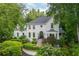 Elegant two-story home surrounded by beautiful landscaping, mature trees, and lush greenery at 341 Lands Se Ml, Marietta, GA 30067
