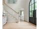 Bright foyer with hardwood floors, a staircase, and an impressive arched front door letting in natural light at 341 Lands Se Ml, Marietta, GA 30067