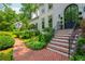 Elegant brick steps leading to a home's grand arched front door, surrounded by decorative landscaping at 341 Lands Se Ml, Marietta, GA 30067