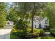 A two-story home with a detached garage surrounded by mature trees and verdant landscaping at 341 Lands Se Ml, Marietta, GA 30067