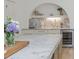 Kitchen featuring marble counters, custom cabinets and an arched shelf at 341 Lands Se Ml, Marietta, GA 30067