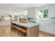 Large kitchen island with seating and marble countertops in a bright and open kitchen at 341 Lands Se Ml, Marietta, GA 30067