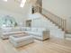 Bright living room boasts a skylight, hardwood floors, and an inviting seating area with a large sectional sofa and ottoman at 341 Lands Se Ml, Marietta, GA 30067