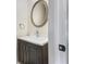 Half bathroom with a modern vanity, faucet, decorative mirror and lighting fixtures at 617 Kyles Cir, Hiram, GA 30141