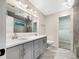 Bathroom with double sink vanity, large mirror, modern lighting, and a glass-enclosed shower at 617 Kyles Cir, Hiram, GA 30141