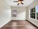 Bright bedroom features hardwood floors, a ceiling fan, and two windows at 617 Kyles Cir, Hiram, GA 30141