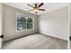 Bedroom with carpeted floors, a ceiling fan, and a window allowing for ample natural light at 617 Kyles Cir, Hiram, GA 30141