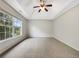 Spacious bedroom boasts carpeted floors, a ceiling fan, and ample natural light from the large window at 617 Kyles Cir, Hiram, GA 30141