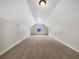 Large, carpeted bonus room with high ceilings, neutral walls, and a single window at 617 Kyles Cir, Hiram, GA 30141