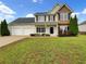 Charming two-story home featuring a manicured lawn and attached two-car garage at 617 Kyles Cir, Hiram, GA 30141