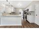 Open kitchen with white cabinets, stainless steel appliances, and a breakfast bar at 617 Kyles Cir, Hiram, GA 30141