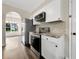 Modern kitchen featuring stainless steel appliances, white cabinets, and tiled backsplash at 617 Kyles Cir, Hiram, GA 30141