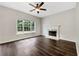 Spacious living room boasts a fireplace, ceiling fan, and large window allowing for ample natural light at 617 Kyles Cir, Hiram, GA 30141