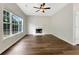 Bright living room featuring a fireplace, large window, and beautiful hardwood floors at 617 Kyles Cir, Hiram, GA 30141