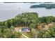 Beautiful aerial view of a lakeside home surrounded by lush trees and serene waters at 7620 Breeze Bay Rd, Cumming, GA 30041