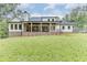 Expansive backyard featuring a covered patio and lush lawn at 7620 Breeze Bay Rd, Cumming, GA 30041