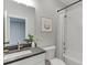 Well-lit bathroom featuring a vanity with black granite, a mirror, and a tiled shower/tub at 7620 Breeze Bay Rd, Cumming, GA 30041