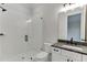 Modern bathroom boasts a glass-enclosed shower, gray countertop, and sleek fixtures, creating a spa-like retreat at 7620 Breeze Bay Rd, Cumming, GA 30041