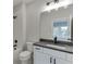 Bathroom featuring a white vanity with a gray countertop, a toilet, and shower-tub combo at 7620 Breeze Bay Rd, Cumming, GA 30041