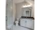 Bright bathroom with a white vanity, grey countertop, a glass-enclosed shower, and a toilet at 7620 Breeze Bay Rd, Cumming, GA 30041