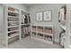 Spacious walk-in closet with custom shelving, hanging rods, and ample storage for clothing and accessories at 7620 Breeze Bay Rd, Cumming, GA 30041