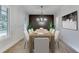 Formal dining room with a large table, seating for eight, elegant chandelier, and natural light at 7620 Breeze Bay Rd, Cumming, GA 30041