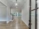Welcoming entryway features gleaming hardwood floors, a staircase, and a view into the spacious living area at 7620 Breeze Bay Rd, Cumming, GA 30041