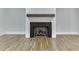 Modern fireplace with hardwood mantelpiece featuring a herringbone patterned interior at 7620 Breeze Bay Rd, Cumming, GA 30041