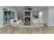 Cozy living room featuring a fireplace, comfortable seating, and sliding glass doors to the backyard at 7620 Breeze Bay Rd, Cumming, GA 30041