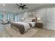 Spacious main bedroom with hardwood floors, large windows, and seating area with natural light at 7620 Breeze Bay Rd, Cumming, GA 30041