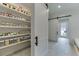 Organized pantry with sliding barn door, shelving, containers, and ample storage for food items at 7620 Breeze Bay Rd, Cumming, GA 30041